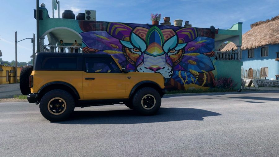 Forza Horizon 5 lion mural location: A yellow jeep parked next to a mural of a multicoloured lion