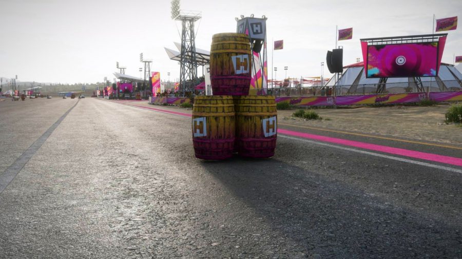 Forza Horizon 5 paint barrel locations: A stack of three wooden paint barrels at the side of a runway in Forza Horizon 5