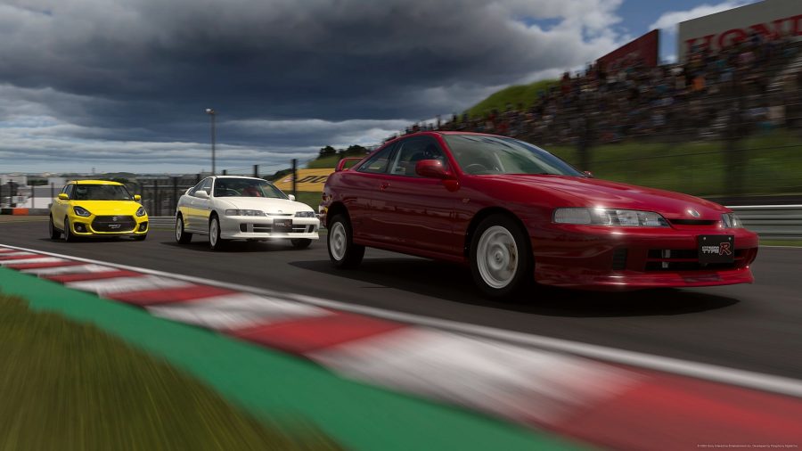 Gran Turismo 7 review: Three cars fly through a quick right-hand corner. There is a yellow Suzuki trailing two Honda sports cars, one white, one red