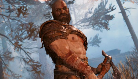 God of War Ragnarök PS5 wishlist release date: Kartos stands, axe in hand, ready to smite down this tree, he also takes note that there could be a release date announcement soon, maybe at Summer Game Fest
