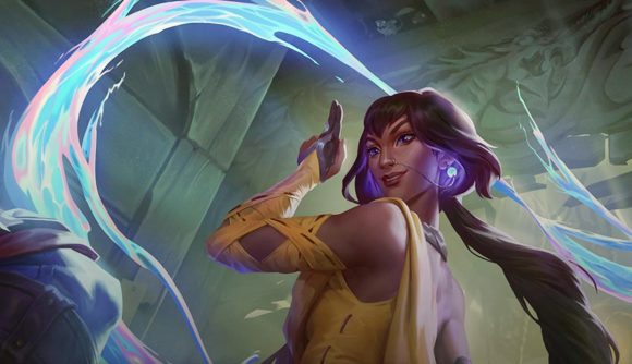 League of Legends Nilah nerf: Nilah points two fingers to the sky as blue and pink light swirls around her