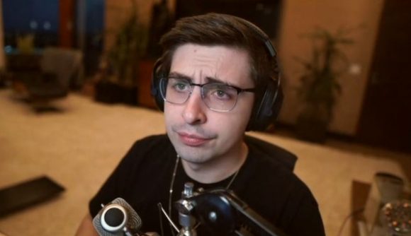 Shroud Valorant esports: Streamer shroud wearing black headphones and a black t shirt, sitting in front of a microphone