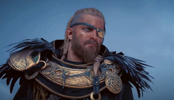 Assassin's Creed Valhalla Forgotten Saga DLC release time: A viking in gold armor with black ravens feathers on the shoulders and a gold eye patch